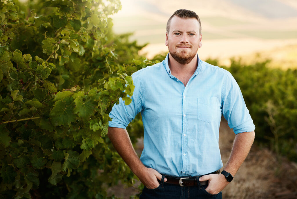 Man in dress shirt standing in vineyard
